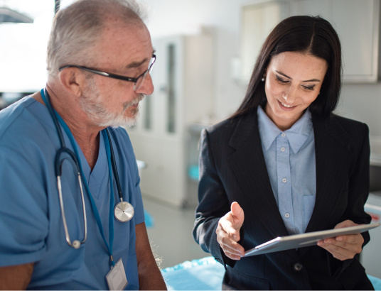 Female healthcare administrator speaking to a doctor
