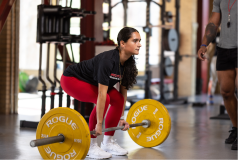 Female student lifting Rogue weights