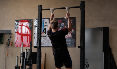 Student doing pull ups.